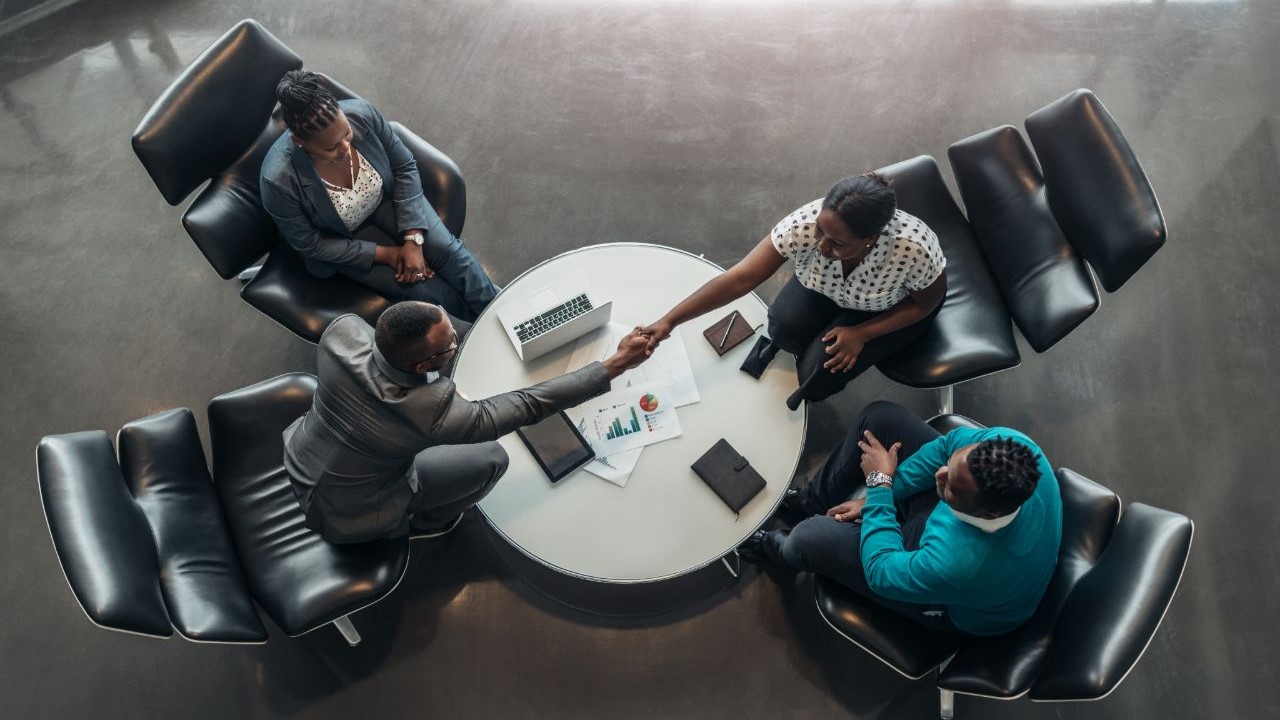 People shaking hands at a meeting